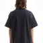 Back view of a model who wears a black vintage overzised T-Shirt 
